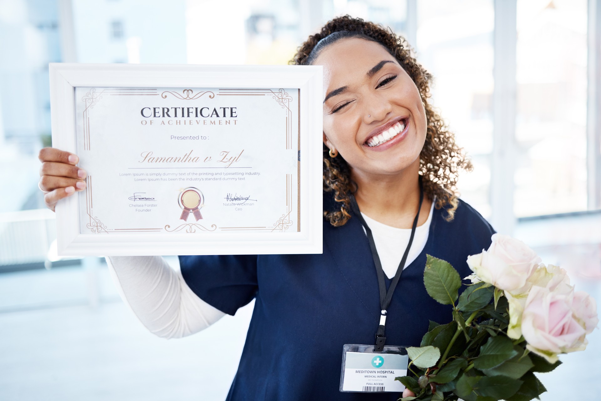 Certificate, flowers and portrait with a black woman graduate or nurse in the hospital, proud of her achievement. Smile, graduation and qualification with a happy young female standing in a clinic